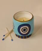 Bonherre mağazasından Paddywax markasına ait, göz desenli seramik kutuda, tütsü ve duman kokulu 226 gr lüks mum.